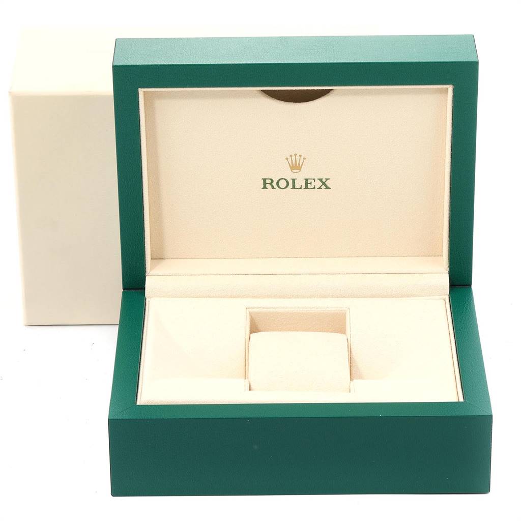 The image shows an open green and cream Rolex watch box for the Milgauss model, displaying the brand's logo inside the lid.