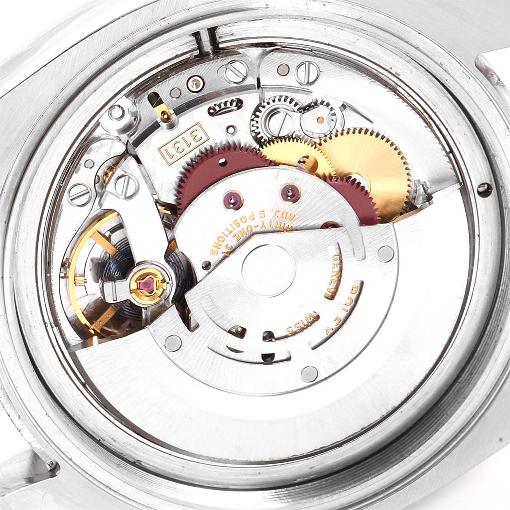 The image shows a close-up view of the internal mechanism of a Rolex Milgauss 116400 Men's Stainless Steel Black Dial 116400 Men's Stainless Steel Black Dial watch, highlighting gears and components.