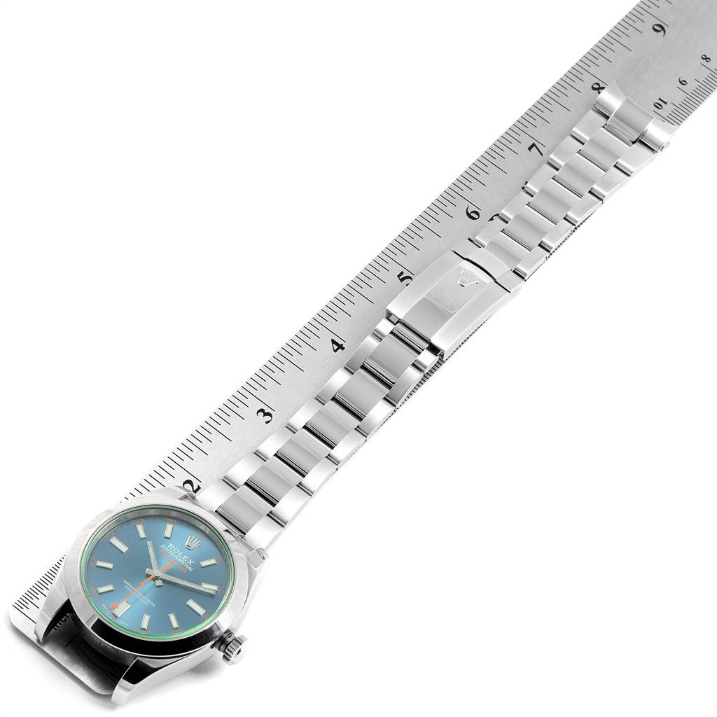 This image shows the Rolex Milgauss 116400GV Men's Stainless Steel Blue Dial 116400GV Men's Stainless Steel Blue Dial watch with its face and stainless steel bracelet, positioned next to a ruler for measurement.