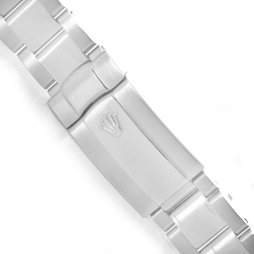 The image shows the clasp of a Rolex Milgauss 116400WSO Men's Stainless Steel White Dial 116400WSO Men's Stainless Steel White Dial watch, featuring the Rolex logo.