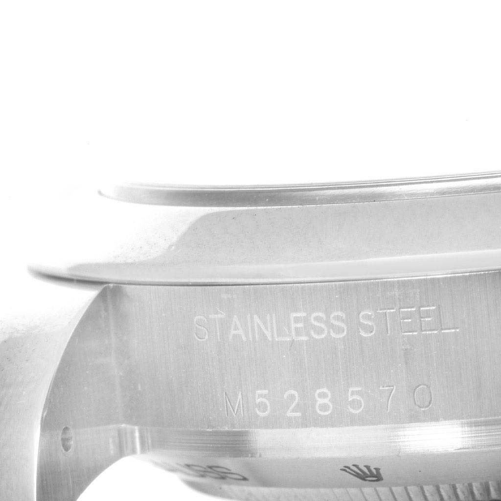 The image shows a close-up of the side of a Rolex Milgauss 116400WSO Men's Stainless Steel White Dial 116400WSO Men's Stainless Steel White Dial watch case, highlighting the stainless steel marking and serial number.