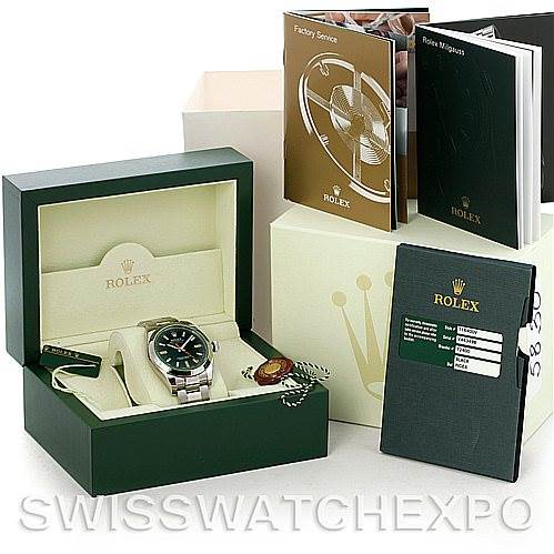 The image shows a Rolex Milgauss 116400V Men's Stainless Steel Black Dial 116400V Men's Stainless Steel Black Dial watch in its box, along with accompanying booklets and accessories, from a front angle.