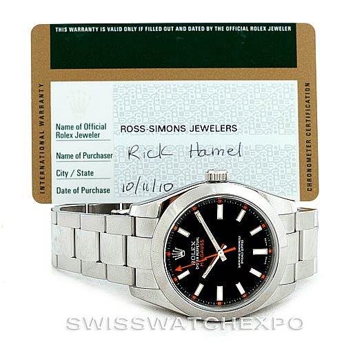 The image shows a front view of a Rolex Milgauss 116400 Men's Stainless Steel Black Dial 116400 Men's Stainless Steel Black Dial watch and its warranty card.