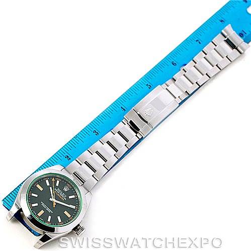 The image shows a top-down view of the Rolex Milgauss 116400V Men's Stainless Steel Black Dial 116400V Men's Stainless Steel Black Dial watch, including its face, bezel, bracelet, and clasp, next to a blue ruler.