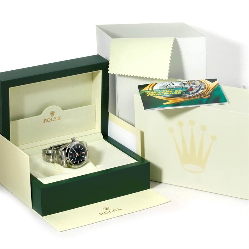 The image shows a Rolex Milgauss 116400 Men
s Stainless Steel Black Dial 116400 Men
s Stainless Steel Black Dial watch placed in its open box, alongside accompanying documentation.