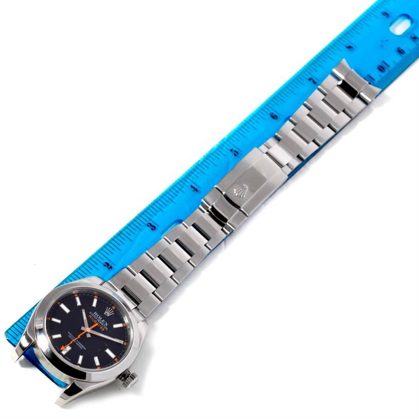 The image shows the face and bracelet of a Rolex Milgauss 116400 Men
s Stainless Steel Black Dial 116400 Men
s Stainless Steel Black Dial watch, laid flat next to a ruler for scale.