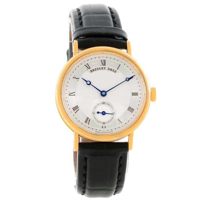 The image shows a frontal view of a Breguet Classique 5907BA/12/984 Men's Yellow Gold Silver Dial 5907BA/12/984 Men's Yellow Gold Silver Dial watch, featuring a gold case, Roman numeral hour markers, and a black leather strap.