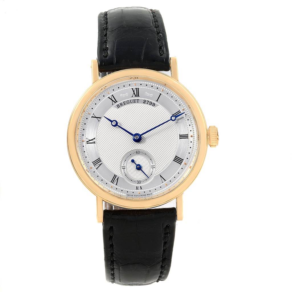 The image shows a frontal view of a Breguet Classique 5907BA/12/984 Yellow Gold Silver Dial 5907BA/12/984 Yellow Gold Silver Dial model watch, highlighting its dial, hands, and leather strap.