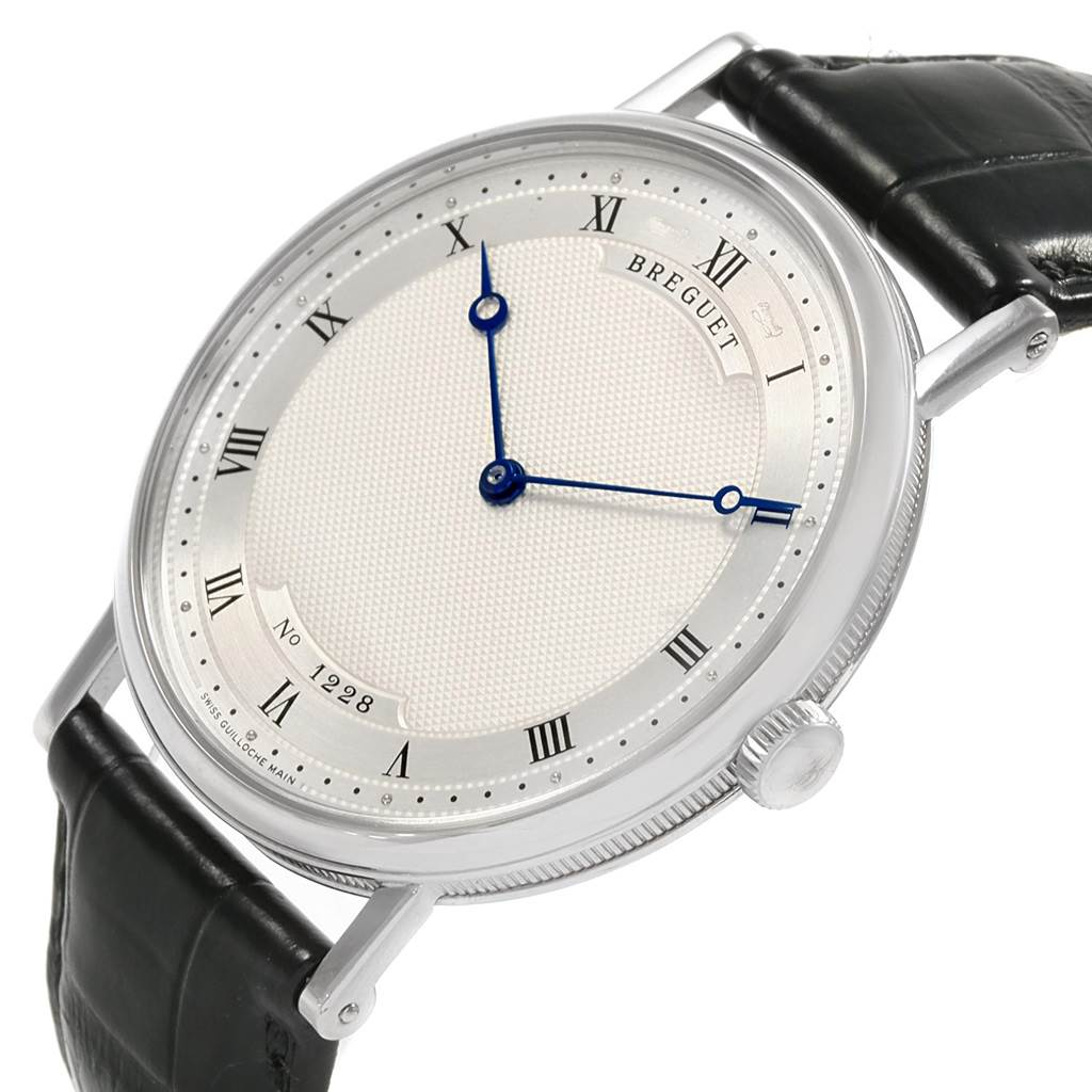 The image shows a Breguet Classique 5157BB/11/9V6 Men's White Gold Silver Dial 5157BB/11/9V6 Men's White Gold Silver Dial watch at a three-quarter angle focusing on the face, dial, crown, and part of the leather strap.
