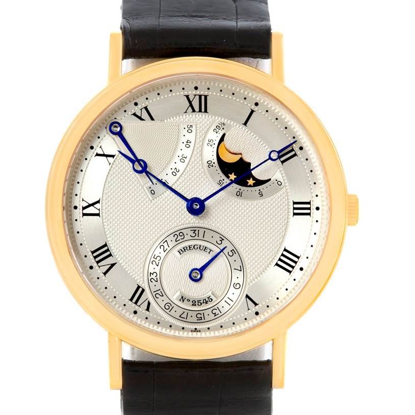The image shows a frontal view of a Breguet Classique 3137BA/11/986 Men's Yellow Gold Silver Dial 3137BA/11/986 Men's Yellow Gold Silver Dial watch, highlighting its intricate dial and moon-phase display.