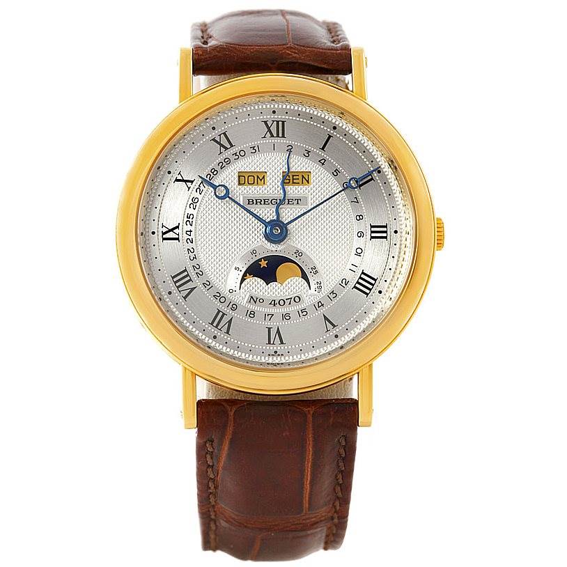 The Breguet 3040 Men's Yellow Gold Silver Dial 3040 Men's Yellow Gold Silver Dial Serpentine 18K Yellow Gold Moon Phase Watch 3040 model is shown from a frontal angle, highlighting its dial and leather strap.