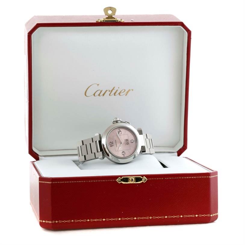 The Cartier Pasha W31058M7 Women
s Stainless Steel Pink Dial W31058M7 Women
s Stainless Steel Pink Dial watch is displayed front-on inside its elegant red box.