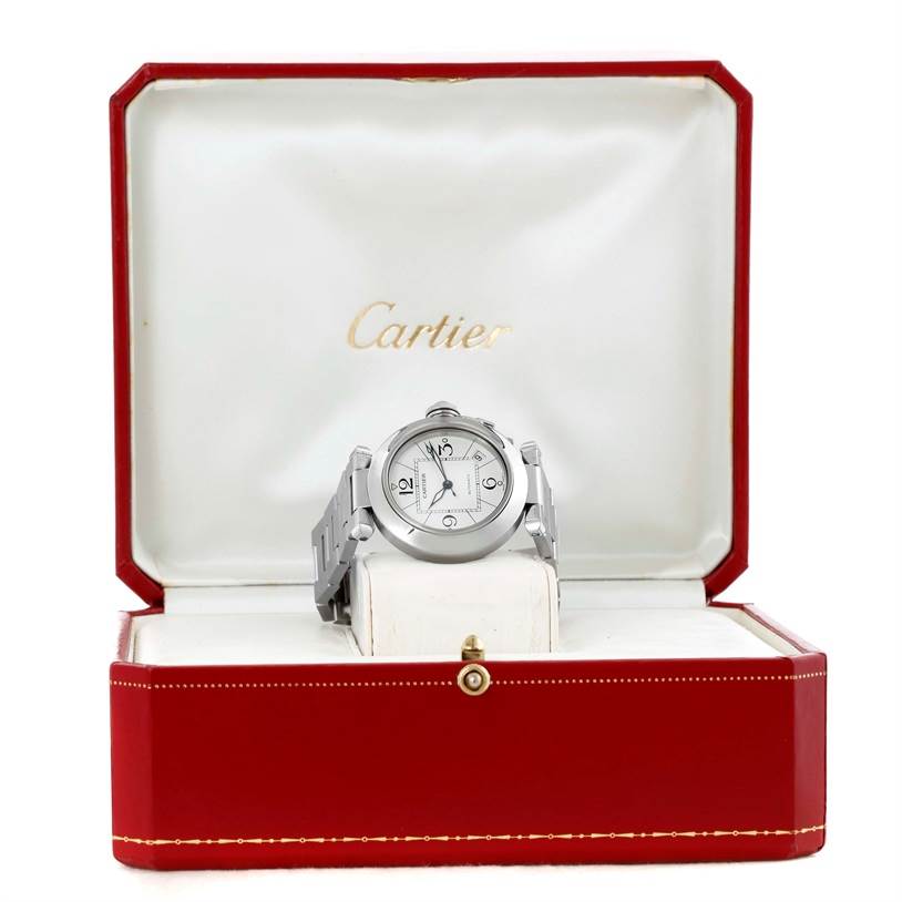 The Pasha model by Cartier is shown head-on inside its open Cartier box.
