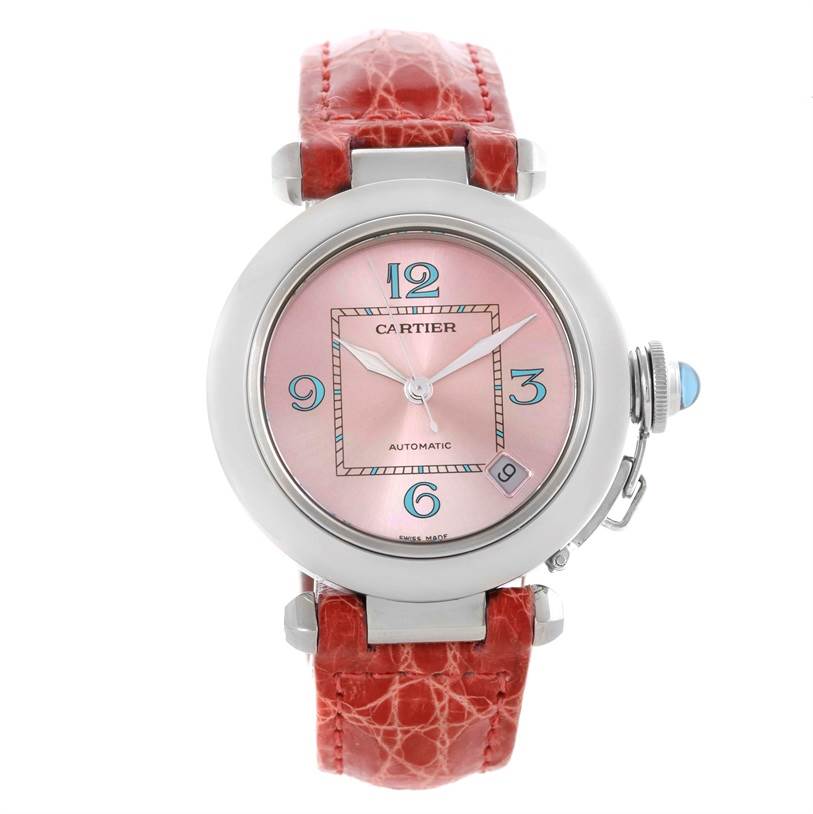 This Cartier Pasha W3108199 Women's Stainless Steel Pink Dial W3108199 Women's Stainless Steel Pink Dial watch is shown from a front angle, displaying the pink dial, red leather strap, and crown.
