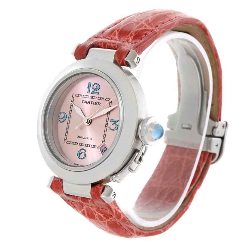 This Cartier Pasha W3108199 Women's Stainless Steel Pink Dial W3108199 Women's Stainless Steel Pink Dial watch is shown at a three-quarter angle, highlighting its face, crown, and red leather strap.