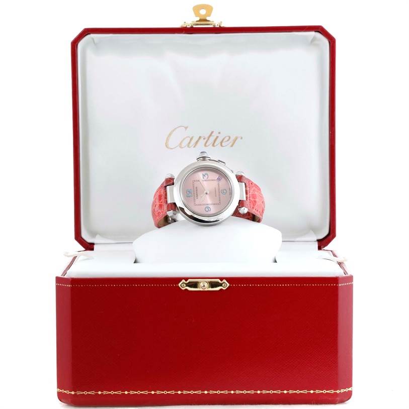The Cartier Pasha W3108199 Women's Stainless Steel Pink Dial W3108199 Women's Stainless Steel Pink Dial watch is displayed frontally in an open red box with a white cushion.