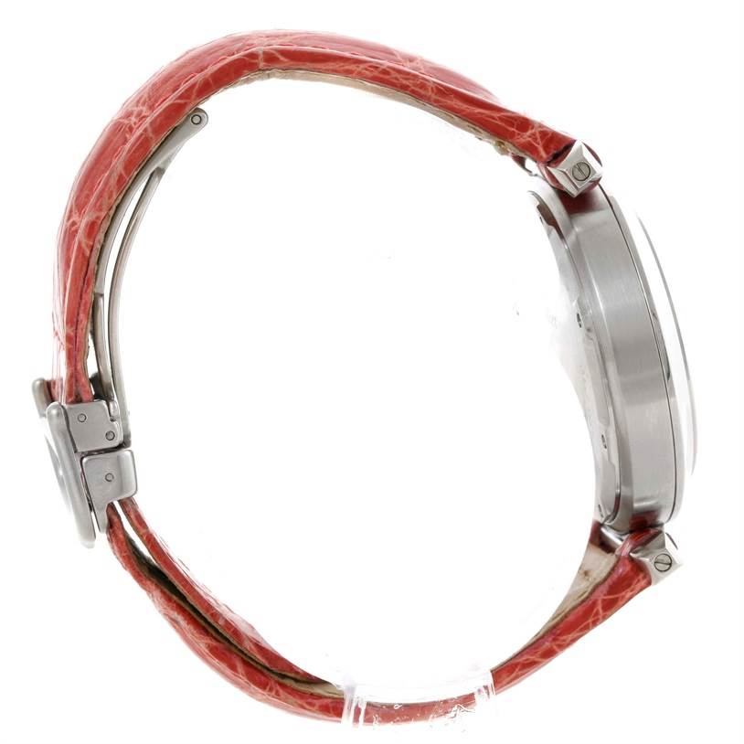 The image shows a side view of a Cartier Pasha W3108199 Women's Stainless Steel Pink Dial W3108199 Women's Stainless Steel Pink Dial watch, highlighting its red strap and stainless steel case.