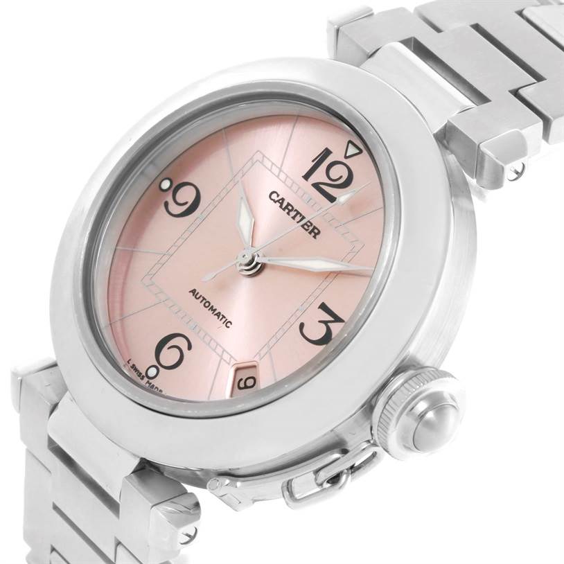The Cartier Pasha W31075M7 Women
s Stainless Steel Pink Dial W31075M7 Women
s Stainless Steel Pink Dial watch is shown at an angled close-up view, highlighting its dial, case, crown, and part of the bracelet.