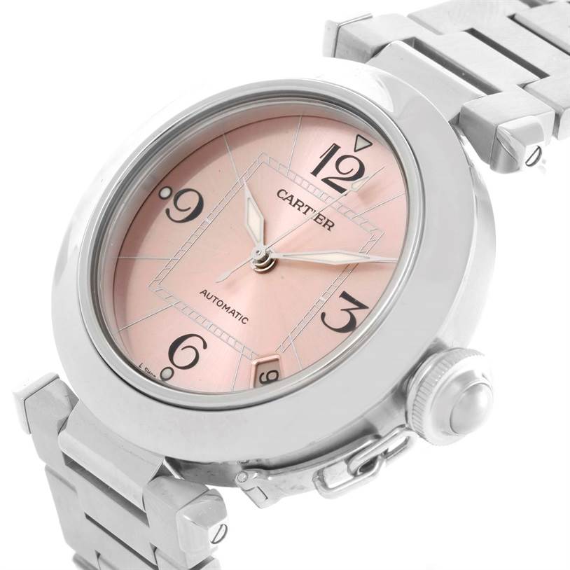The image shows a Cartier Pasha W31075M7 Women's Stainless Steel Pink Dial W31075M7 Women's Stainless Steel Pink Dial watch at an angle highlighting its pink dial, crown, and part of its metal bracelet.