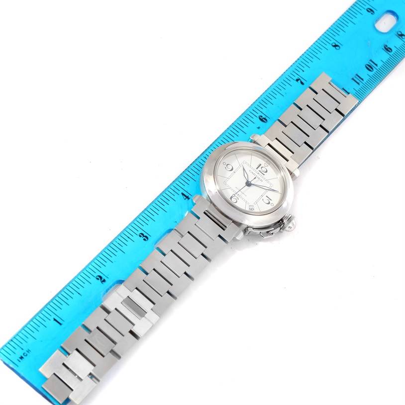 The Cartier Pasha W31074M7 Women's Stainless Steel White Dial W31074M7 Women's Stainless Steel White Dial watch is shown at an angle, displaying its face, bracelet, and part of the case, measured alongside a ruler.