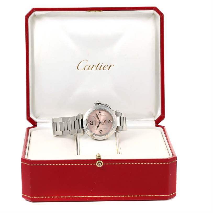 This image shows a Cartier Pasha W31058M7 Women's Stainless Steel Pink Dial W31058M7 Women's Stainless Steel Pink Dial watch with a metal bracelet, displayed in an open red and white Cartier box from a frontal angle.
