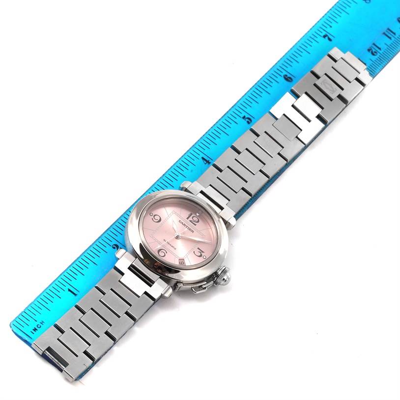 The Cartier Pasha W31075M7 Women's Stainless Steel Pink Dial W31075M7 Women's Stainless Steel Pink Dial watch is shown from a top-down angle, featuring its face, case, and stainless steel bracelet.