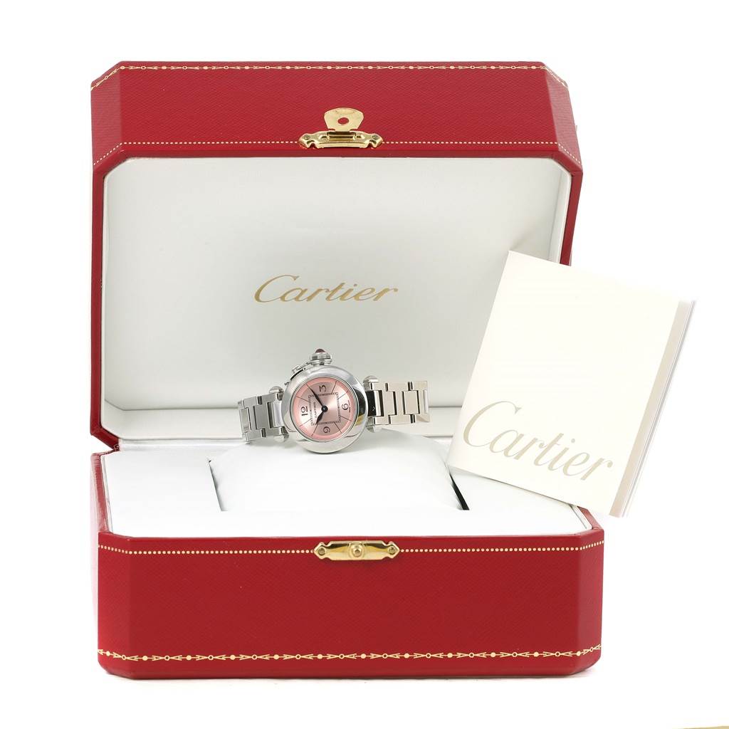 The image shows a Cartier Pasha W3140008 Women's Stainless Steel Pink Dial W3140008 Women's Stainless Steel Pink Dial watch in its open red box with a booklet beside it.