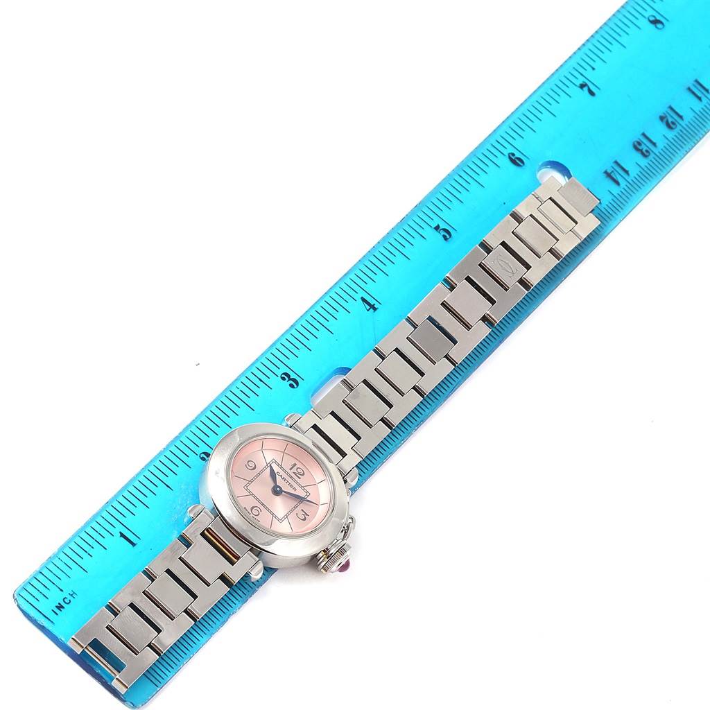 The image shows a Cartier Pasha W3140008 Women's Stainless Steel Pink Dial W3140008 Women's Stainless Steel Pink Dial watch laid flat along a blue ruler, displaying the band and face of the watch.