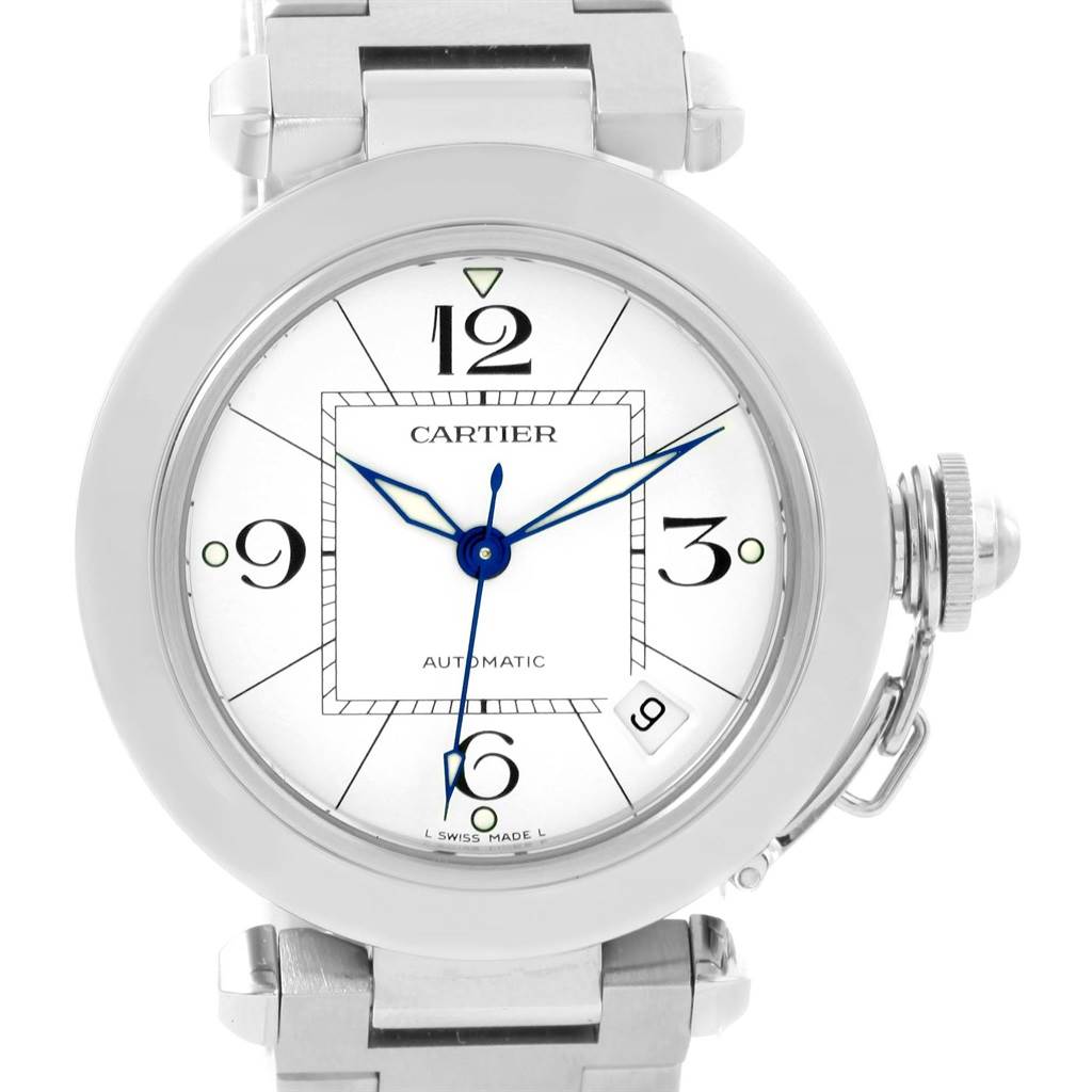 The Cartier Pasha W31074M7 Women's Stainless Steel White Dial W31074M7 Women's Stainless Steel White Dial watch is shown from a front angle, displaying its round face, blue hands, and metal bracelet.