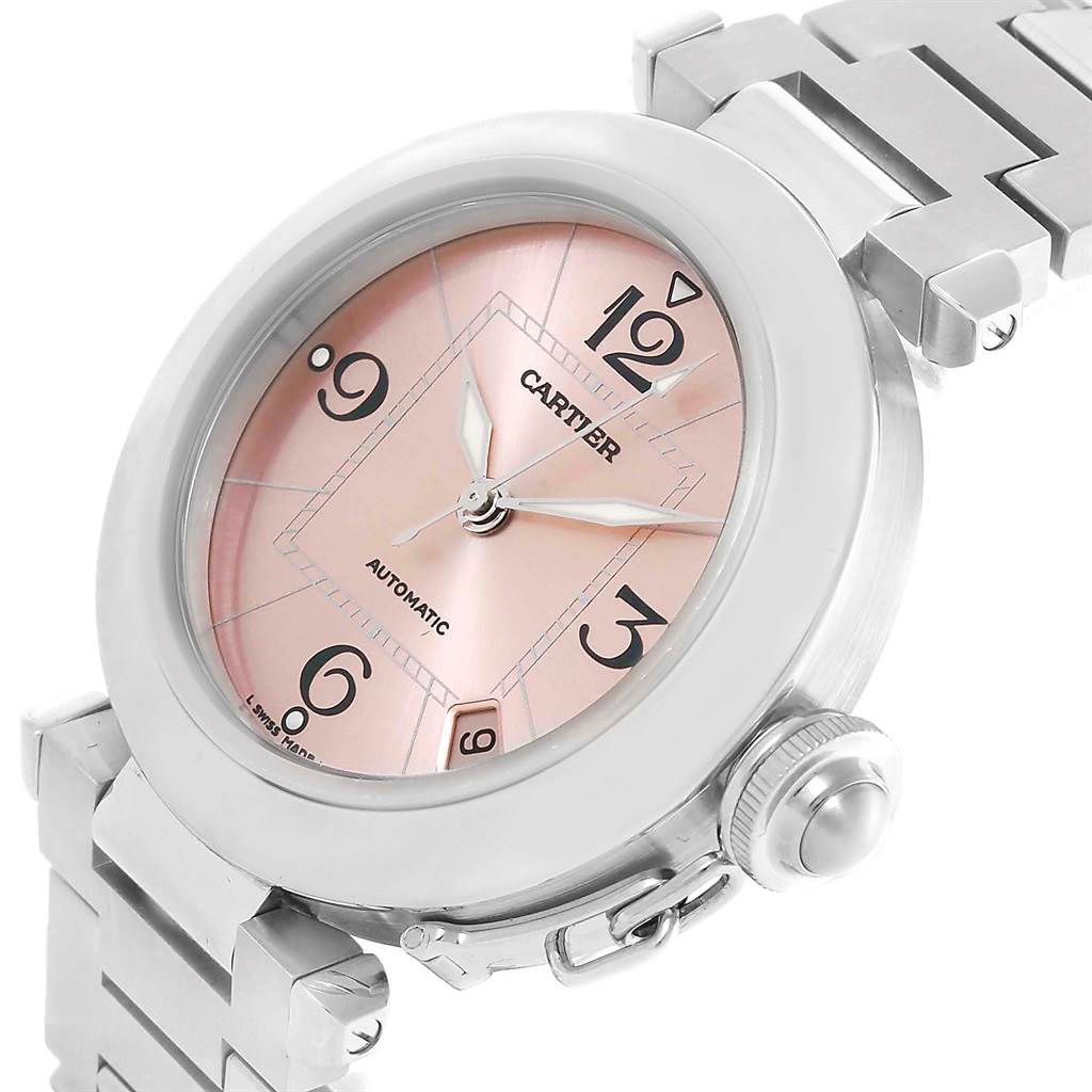 The image shows a close-up of the Cartier Pasha W31075M7 Women
s Stainless Steel Pink Dial W31075M7 Women
s Stainless Steel Pink Dial watch, highlighting its face, crown, and part of the bracelet.