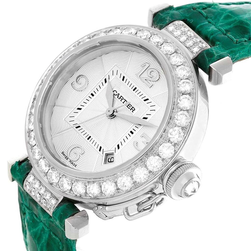 This Pasha model by Cartier is shown from an angled view, displaying the face, diamond bezel, and green strap.