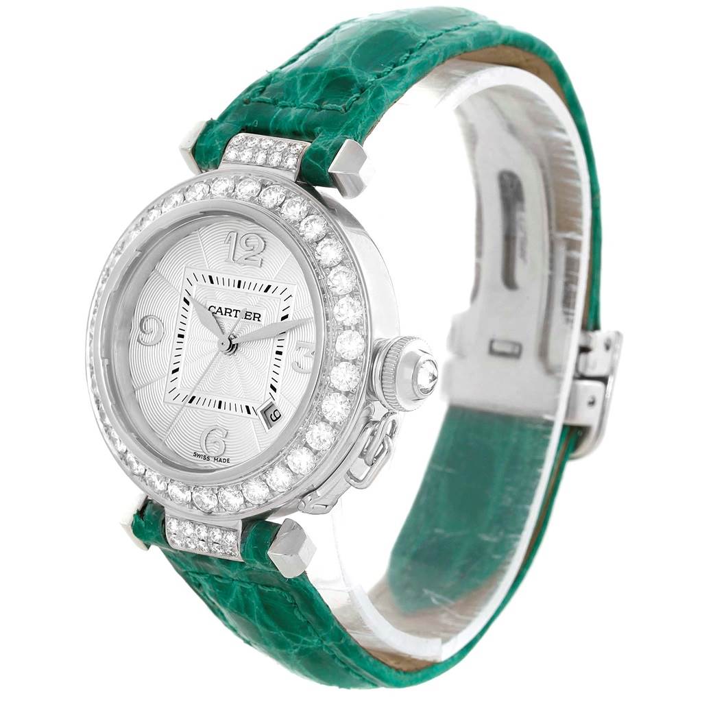 The Cartier Pasha WJ116136 Men's White Gold Silver Dial WJ116136 Men's White Gold Silver Dial watch is shown from an angled front view, highlighting its face, bezel, and green strap.