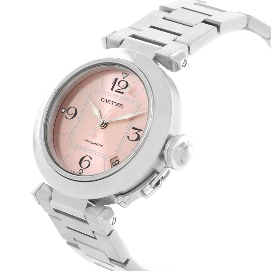 The Cartier Pasha W31075M7 Men's Stainless Steel Pink Dial W31075M7 Men's Stainless Steel Pink Dial watch is shown from an angled side view, highlighting the face, crown, and metal bracelet.