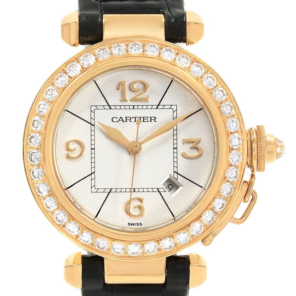 The Cartier Pasha Women's Yellow Gold Silver Dial Women's Yellow Gold Silver Dial watch is shown face-on, highlighting its round dial, diamond-studded bezel, and black leather strap.