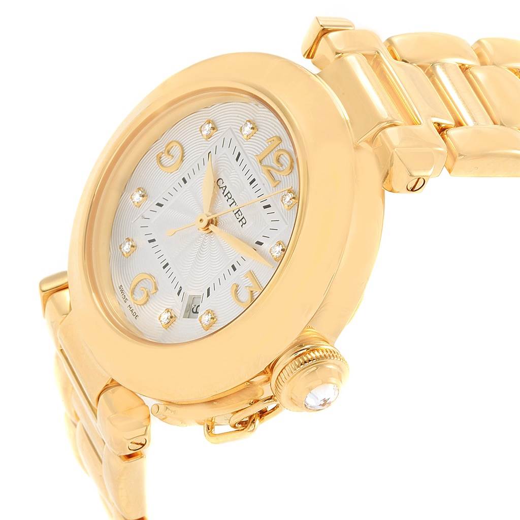 The image shows a gold Cartier Pasha 2397 Women's Yellow Gold Silver Dial 2397 Women's Yellow Gold Silver Dial watch angled to display the face, crown, and link bracelet.
