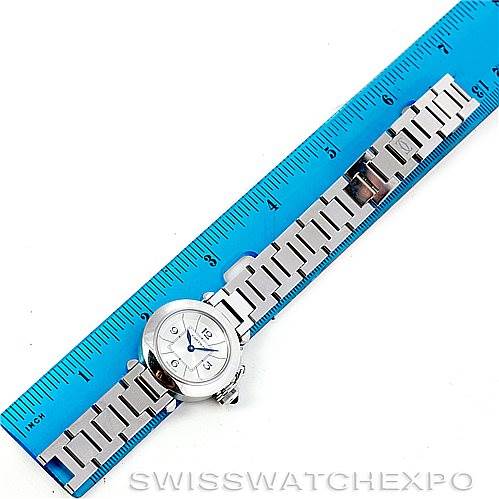 The image shows a top-down view of a Cartier Pasha W31043M7 Women
s Stainless Steel Silver Dial W31043M7 Women
s Stainless Steel Silver Dial watch, focusing on the watch face and metal bracelet, alongside a blue ruler for scale.