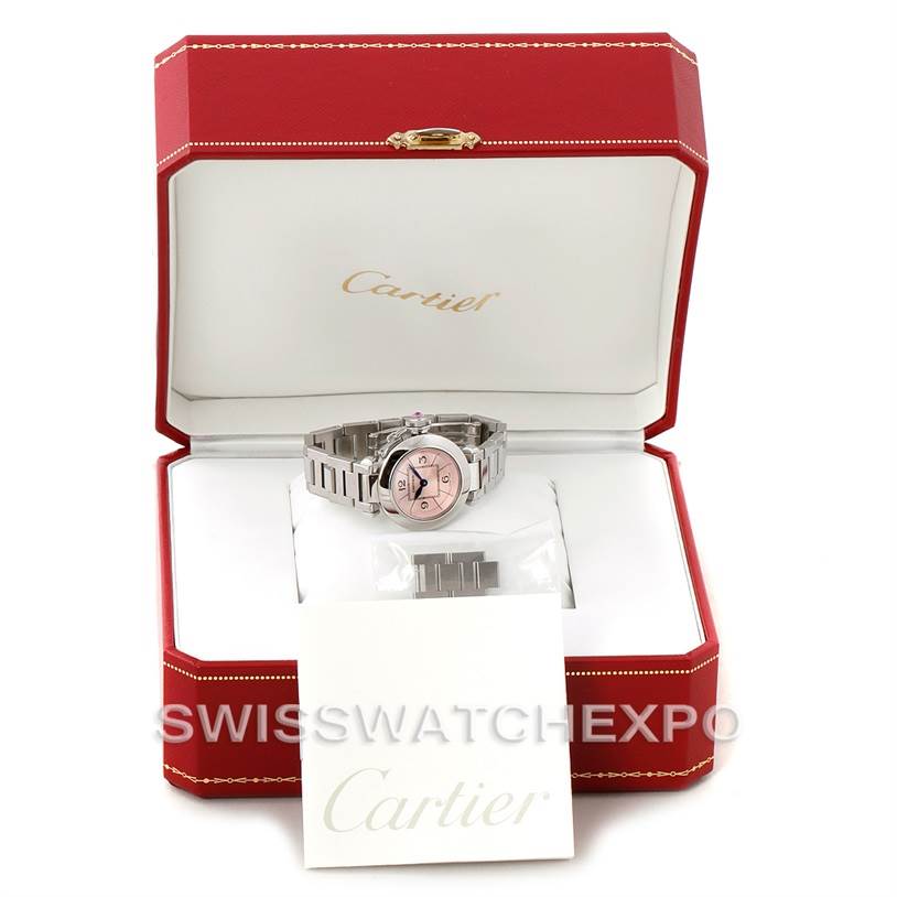 The Pasha de Cartier watch is shown from the front within its open red Cartier box, accompanied by extra links and a booklet.