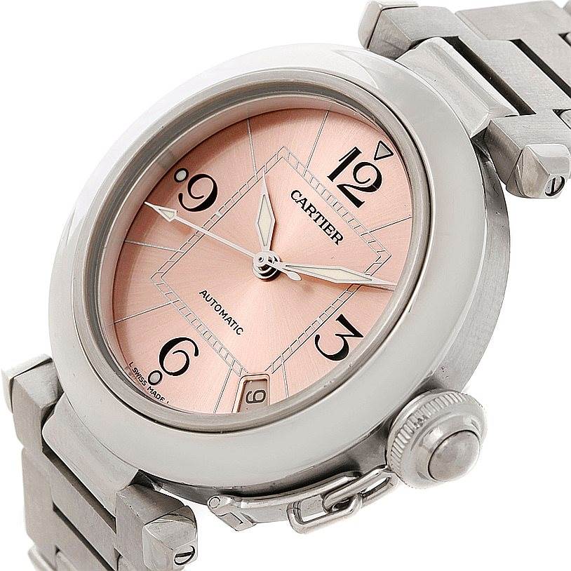 The Cartier Pasha W31075M7 Women
s Stainless Steel Pink Dial W31075M7 Women
s Stainless Steel Pink Dial watch is shown at a slight angle, displaying its face, bezel, crown, and part of the bracelet.