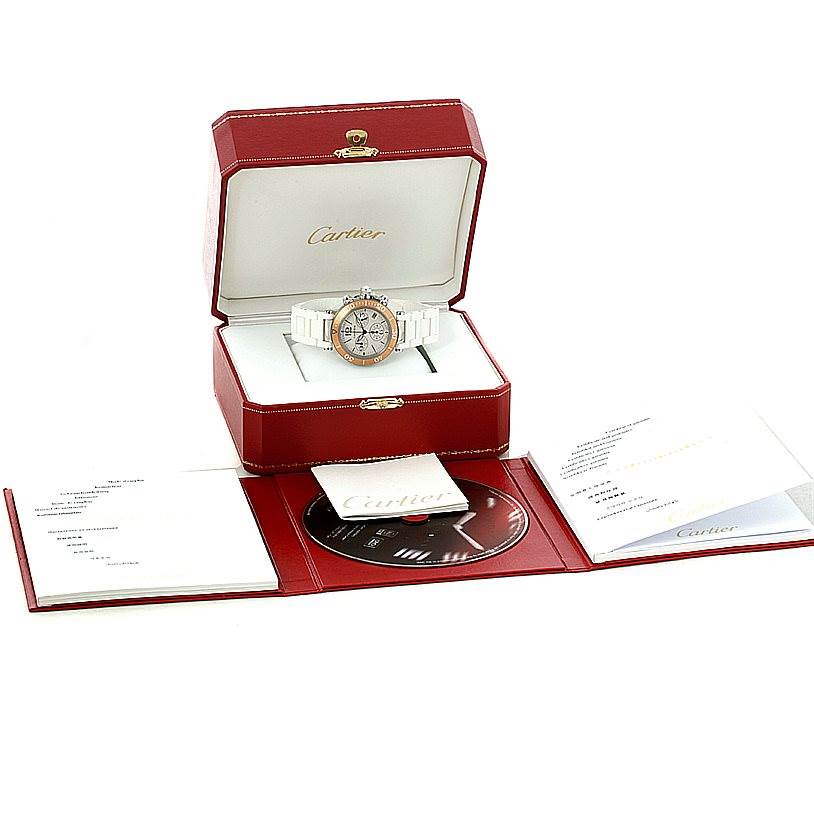 The image shows the Cartier Pasha W3140004 Men
s Stainless Steel Silver Dial W3140004 Men
s Stainless Steel Silver Dial watch at an angle, inside its red case, along with accompanying documents and a CD.