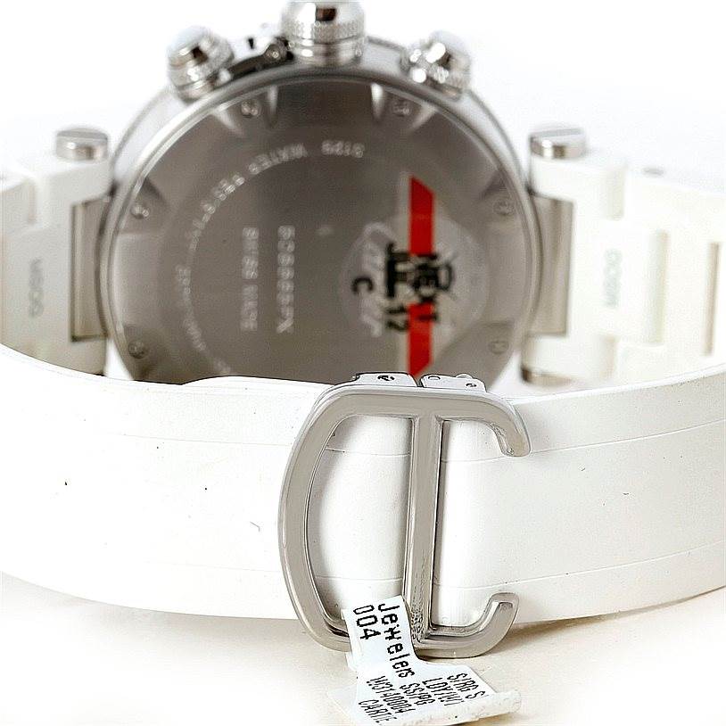 The image shows the back of a Cartier Pasha W3140004 Men
s Stainless Steel Silver Dial W3140004 Men
s Stainless Steel Silver Dial watch and its clasp with a white strap.