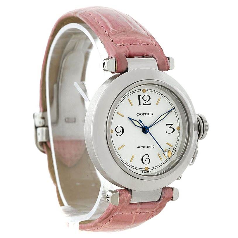 The Cartier Pasha W31015M7 Women's Stainless Steel White Dial W31015M7 Women's Stainless Steel White Dial watch is shown from a front angle, highlighting its round face, pink strap, and metallic casing.