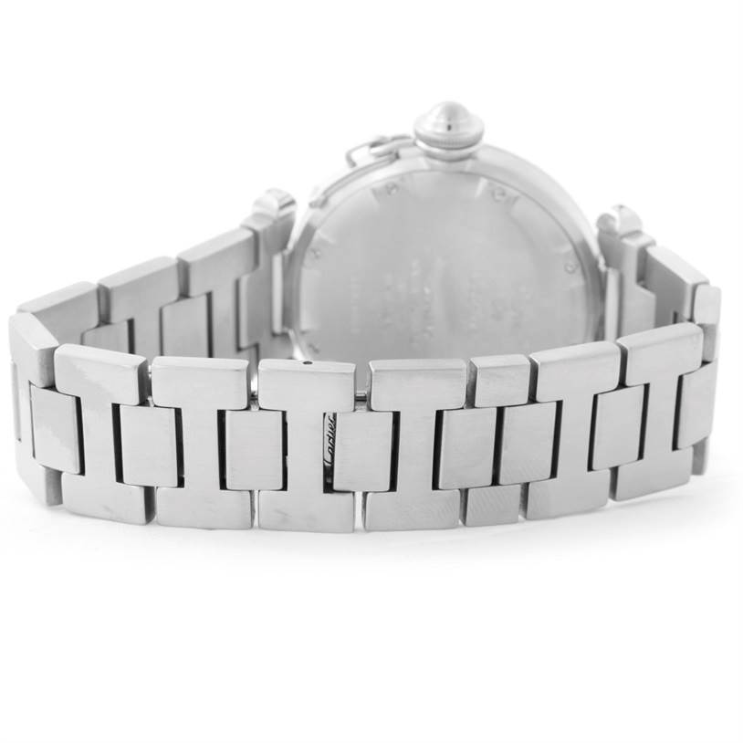 The image shows the back view of a Pasha by Cartier watch, focusing on the stainless steel bracelet and case back.