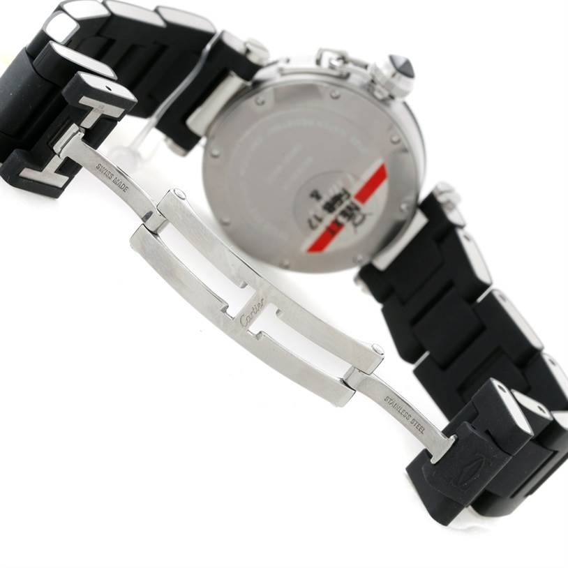 The image shows the back of a Pasha de Cartier watch and its stainless steel and black bracelet.