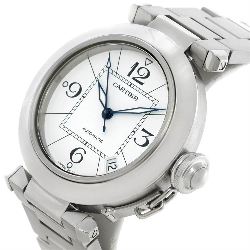 The image shows a close-up of the dial, crown, and part of the bracelet of a Cartier Pasha W31074M7 Women's Stainless Steel White Dial W31074M7 Women's Stainless Steel White Dial watch.