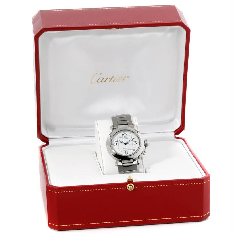 The Cartier Pasha W31074M7 Women's Stainless Steel White Dial W31074M7 Women's Stainless Steel White Dial watch is displayed front-facing in its open red and white case.