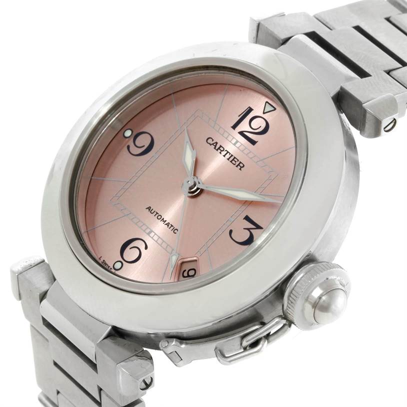The image shows a close-up of the Cartier Pasha W31075M7 Women
s Stainless Steel Pink Dial W31075M7 Women
s Stainless Steel Pink Dial watch face and part of its metal bracelet at an oblique angle.
