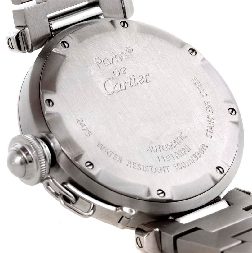 The image shows the back case, crown, and part of the bracelet of a Cartier Pasha 9791 Women
s Stainless Steel Pink Dial 9791 Women
s Stainless Steel Pink Dial watch.