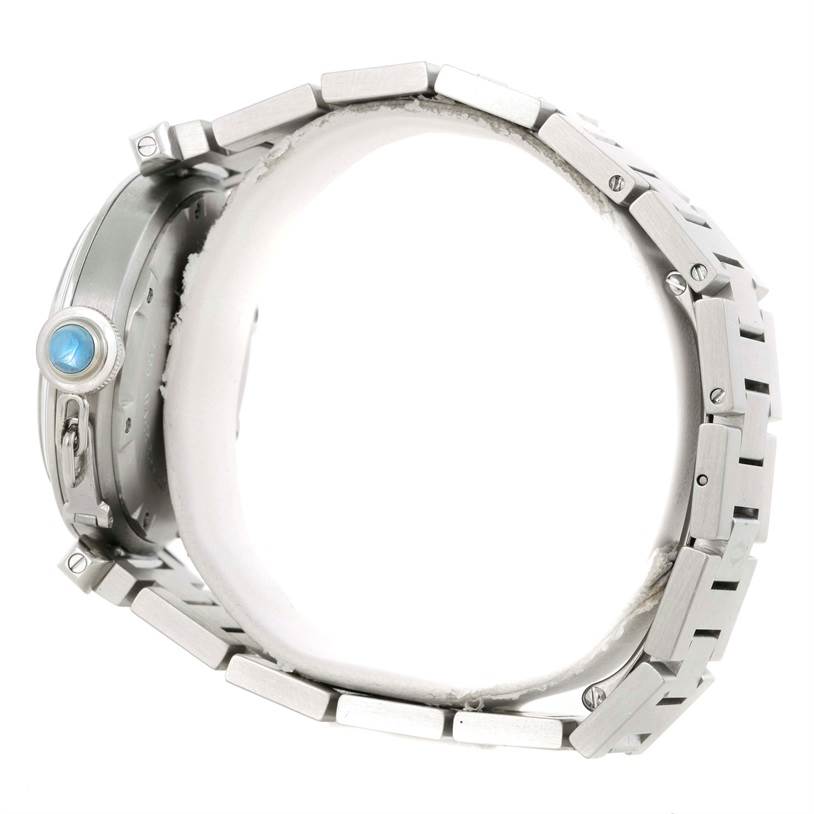 The image shows a side view of a Cartier Pasha W3108199 Women's Stainless Steel Pink Dial W3108199 Women's Stainless Steel Pink Dial model watch, highlighting its bracelet and crown with a blue cabochon.