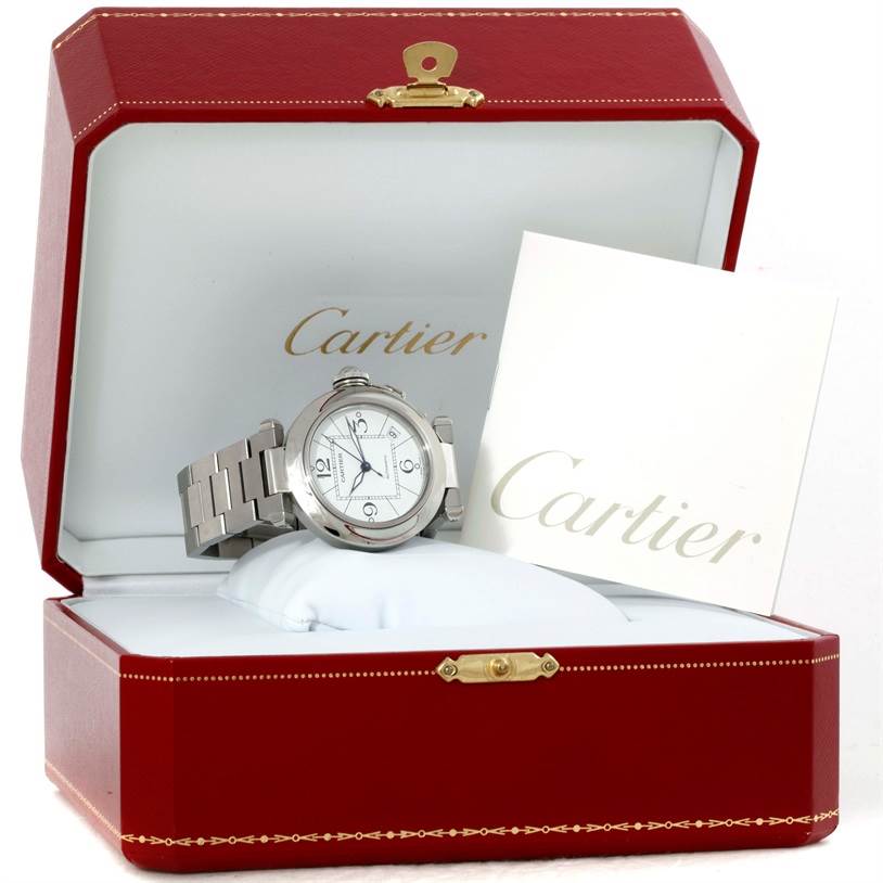 The Pasha model by Cartier is shown at an angled view inside an open red Cartier box with accompanying documentation.