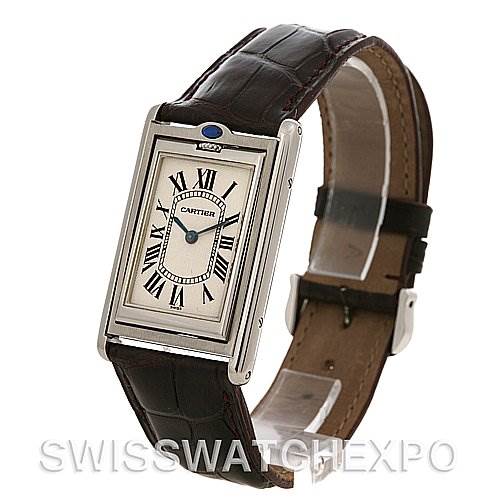 This image shows a Cartier Tank Basculante W1011358 Stainless Steel Silver Dial W1011358 Stainless Steel Silver Dial watch at an angle showcasing its rectangular face, Roman numerals, and leather strap.